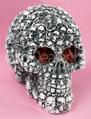 skull head toy on pink background