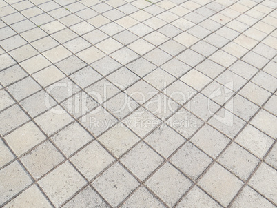 View of floor in square blocks of cement on the diagonal.