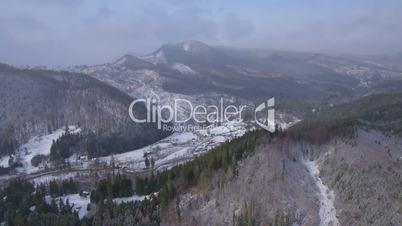 Aerial footage of small village in the mountains in winter