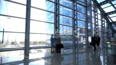 Business people walking in glass building