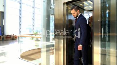 Business people coming out of elevator