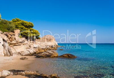 Sunny beautiful summer sea view with Greek blue sea and shallow