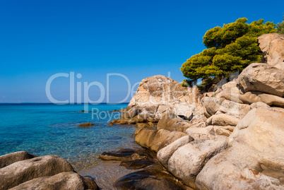 Sunny beautiful summer sea view with Greek blue sea and shallow