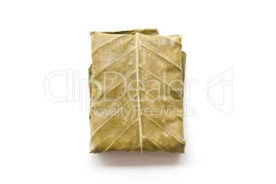 Raw tempeh wrapped in leaf isolated white.