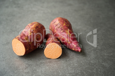 sweet potatoes on dark background.