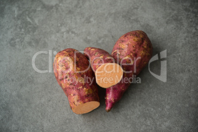 sweet potatoes over dark table