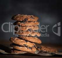 stack of round chocolate chip cookies on brown paper