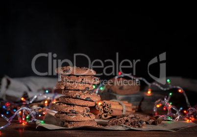 round chocolate cookies in a stack, around the New Year's burnin