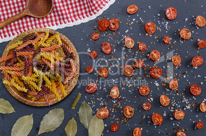 unprepared multi-colored pasta spiral made from wheat flour and