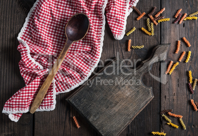 empty wooden cutting board, wooden spoon on a red towel