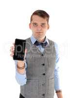 Young man holding up his cell phone in a vest