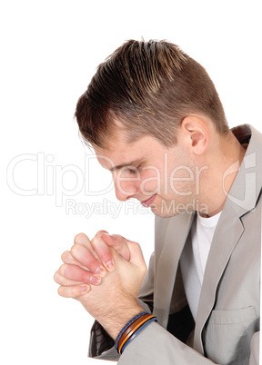 Young man praying with hands folded