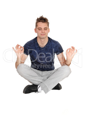 Young man sitting on floor in a yoga pose