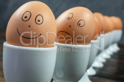 Happy and Sad Emotion Concept Eggs in Egg Cups on a Table