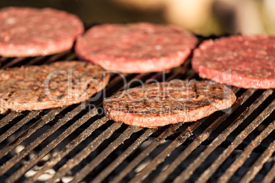 Hamburgers cooking on grill