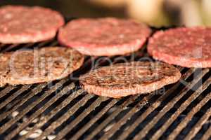 Hamburgers cooking on grill