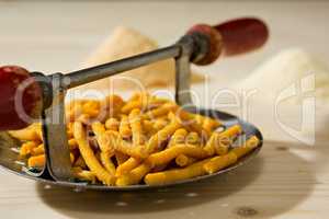 Closeup of Passatelli original Italian pasta on its tool