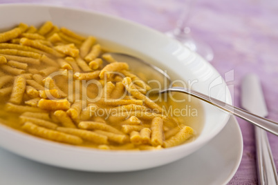 Closeup of Passatelli in broth original Italian pasta