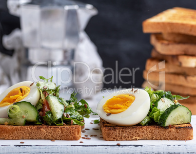 square pieces of bread from white wheat flour with boiled egg