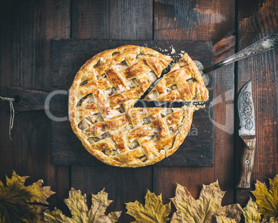 classic American apple pie with puff pastry on an old brown kitc