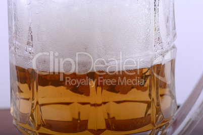 Mug fresh beer with cap of foam close up