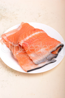 fresh salmon fillet close up on white plate