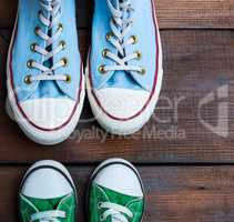 green and blue textile sneakers on a brown wooden surface