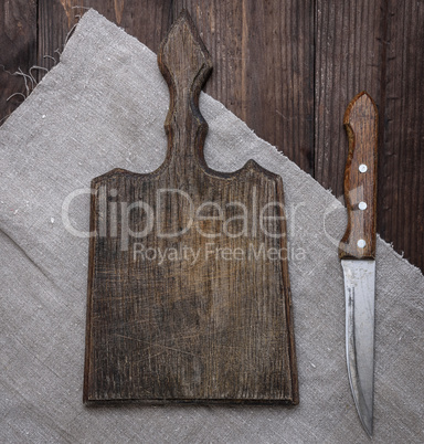 empty old brown wooden cutting board and knife on the table
