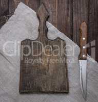 empty old brown wooden cutting board and knife on the table