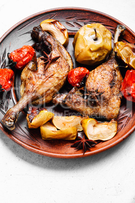 Fried duck leg on a white plate