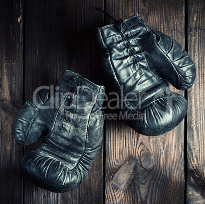 pair of black leather very old boxing gloves