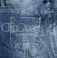 fragment of blue textile jeans with a back pocket