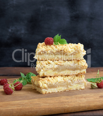 slices of apple crumble cake on brown wooden board