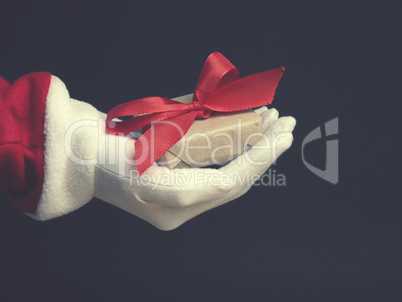 Hand of Santa with a gift box