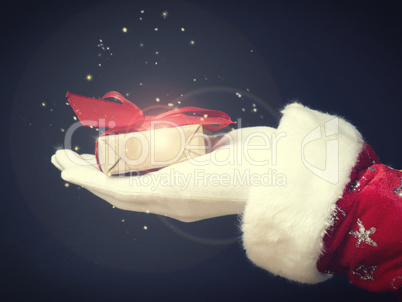 Hand of Santa with a gift box