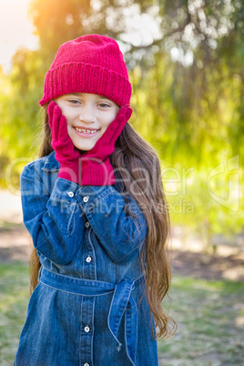 Cute Mixed Race Young Girl Wearing Red Knit Cap and Mittens