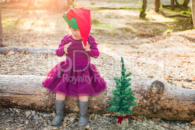 Mixed Race Toddler Girl in Santa With a Christmas Tree