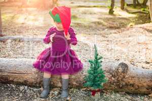 Mixed Race Toddler Girl in Santa With a Christmas Tree