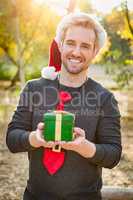 Handsome Festive Young Caucasian Man Holding Christmas Gift