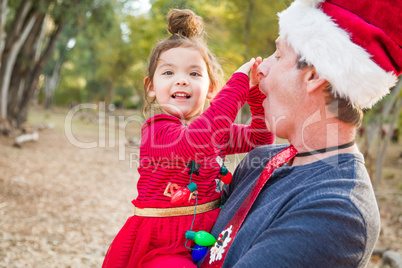 Festive Grandfather and Mixed Race Baby Girl Outdoors