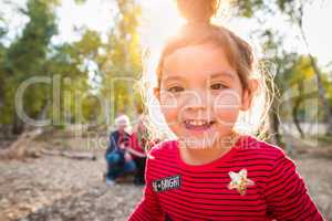 Cute Mixed Race Baby Girl Christmas Portrait With Family Behind