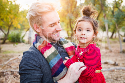 Handsome Caucasian Young Man with Mixed Race Baby Girl Outdoors