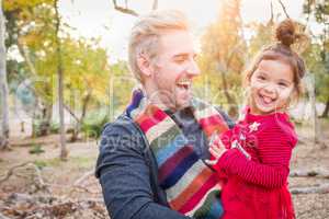 Handsome Caucasian Young Man with Mixed Race Baby Girl Outdoors