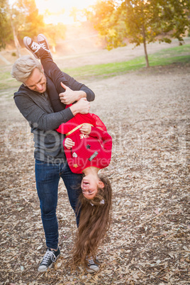 Playful Caucasian Young Man with Mixed Race Girl Having Fun Outdoors