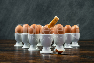 Toast Soldier Dipped Into Boiled Egg in Egg Cup on a Table