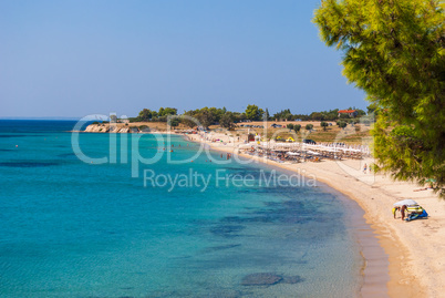 Sunny beautiful summer view of the sandy beach with Greek blue s