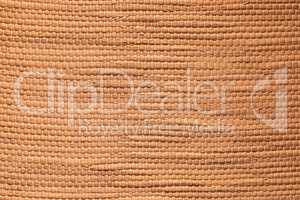 Tan textured bamboo fabric background