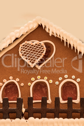 Gingerbread house with white icing and heart shaped windows with