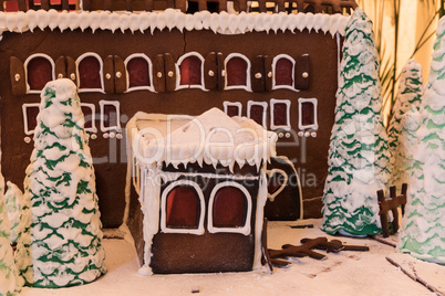 Gingerbread house with white icing and heart shaped windows with