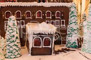 Gingerbread house with white icing and heart shaped windows with